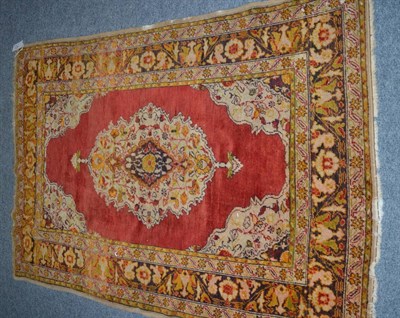 Lot 1118 - Kayseri rug, Central Anatolia, the plain brick red field centred by a pole medallion framed by...