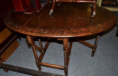 Lot 1140 - An 1920s oak Lunette carved drop leaf table