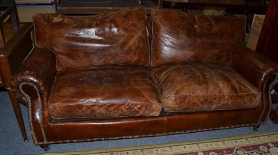 Lot 1167 - A brown leather two seater settee