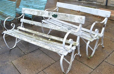 Lot 1185 - A pair of white painted wrought iron and slatted wood garden benches (a.f.)