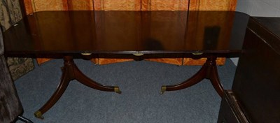 Lot 1189 - A Regency style mahogany twin pillar dining table