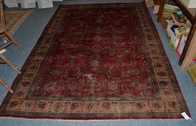 Lot 1240 - A Tabriz Carpet, the crimson field of palmettes and vines enclosed by ivory borders, 281cm by 197cm