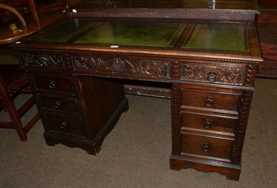 Lot 1284 - A carved oak pedestal desk