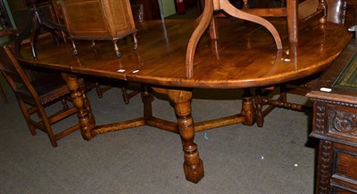 Lot 1286 - A Titchmarsh &amp; Goodwin oak trestle dining table with two leaves and a set of six...