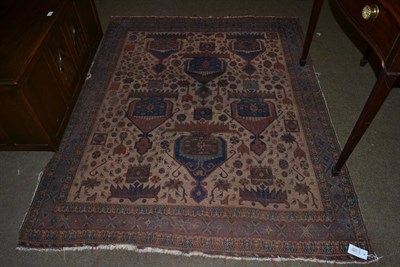 Lot 1294 - An Afshar Rug, the pale camel field with six heraldic devices, surrounded by tribal motifs enclosed