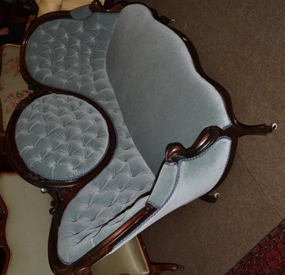 Lot 1310 - A Victorian walnut framed buttoned medallion back settee upholstered in pale blue velour