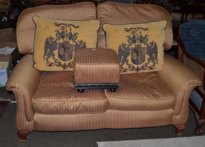 Lot 1318 - A modern two seater settee upholstered in gold and bronze striped weave, with a similarly...