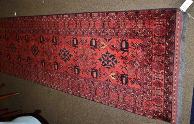 Lot 1330 - A narrow Beshir Runner, North Afghanistan, the madder field with a column of cruciform...