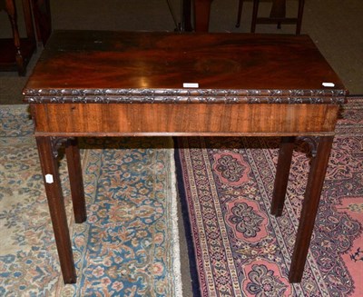 Lot 1335 - A George III mahogany fold over card table