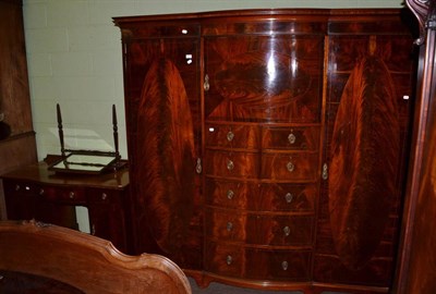 Lot 1368 - Edwardian mahogany break bowfront wardrobe, pedestal dressing table and a toilet mirror