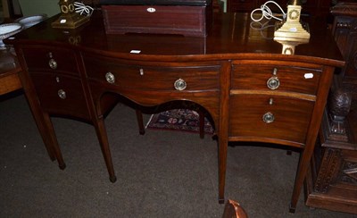 Lot 1373 - A mahogany serpentine front sideboard in a Georgian style