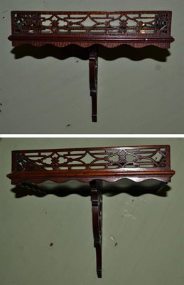 Lot 1383 - A pair of mahogany rectangular wall brackets in George III style, each with a three quarter pierced