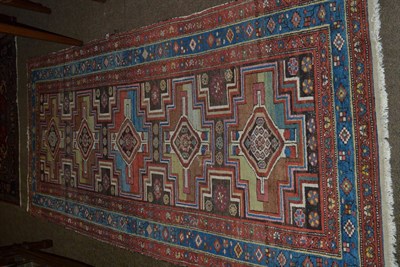 Lot 1384 - Kurdish rug, Iranian Azerbaijan, the charcoal field with five cruciform medallions enclosed by...