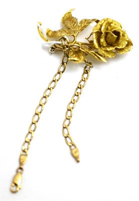 Lot 11 - A floral brooch, reverse stamped '750' and a curb link bracelet, clasp stamped '375' (2)