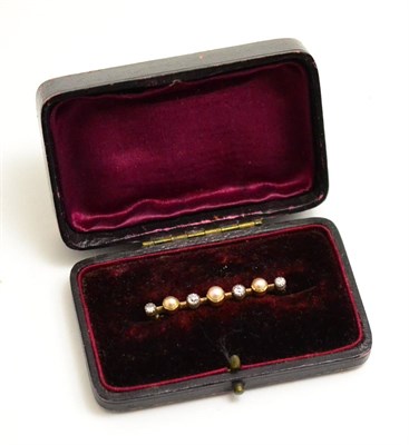 Lot 12 - A pearl and diamond bar brooch, three split pearls alternate with four old cut diamonds in...