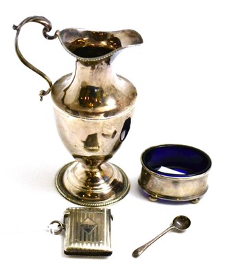 Lot 28 - A George III silver cream jug, salt and vesta case