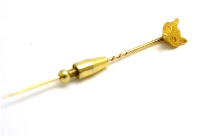 Lot 46 - A yellow metal fox head stick pin, stamped '18'