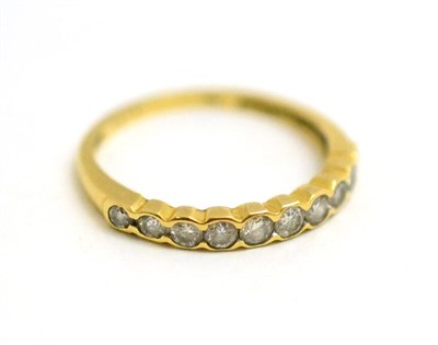 Lot 51 - A diamond half eternity ring stamped '750'