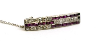 Lot 52 - An Art Deco ruby and diamond brooch, old cut diamonds and calibré cut rubies in white...