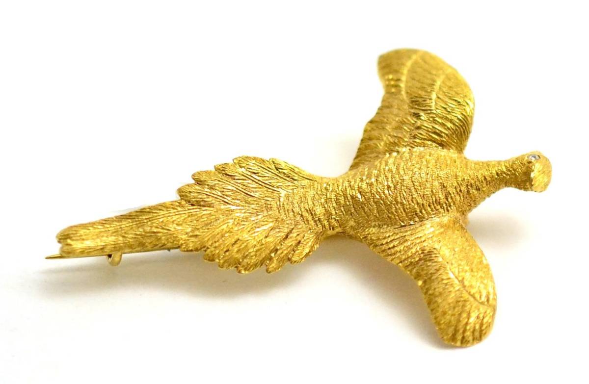 Lot 53 - A pheasant brooch, realistically modelled to depict the bird in flight, set with a rose cut diamond