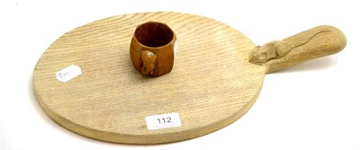 Lot 112 - A Robert Mouseman Thompson oak bread board and napkin ring (2)