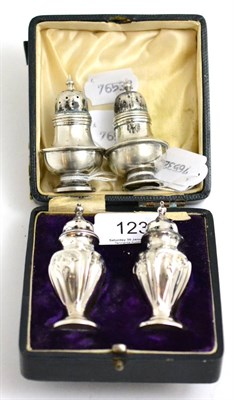 Lot 123 - Two pairs of silver pepperettes, one in a case