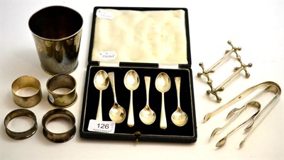 Lot 126 - Three pairs of silver tongs, four silver napkins rings, silver beaker and six silver spoon cases