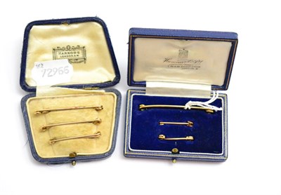 Lot 141 - A trio of pin bars, each stamped 9ct, case by Harrods, and another cased trio