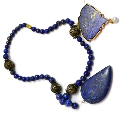 Lot 146 - A lapis lazuli necklace with drop shaped pendant and a lapis lazuli pendant with pearl suspended