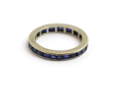 Lot 175 - A sapphire eternity ring, the step cut sapphires channel set within a flat sided shank