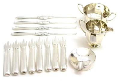 Lot 191 - A silver cream jug and sugar bowl, a pair of sugar tongs, a silver ashtray, eight plated oyster...
