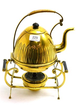 Lot 229 - An Aesthetic Movement brass spirit kettle on stand
