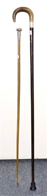 Lot 266 - A Chinese white metal-mounted bovine horn walking stick, circa 1910, with metal tip, tapering shaft
