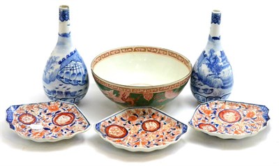 Lot 326 - A group of Oriental ceramics including: a pair of Chinese blue and white bottle vases, a set of...