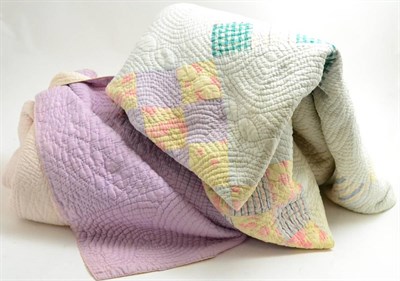 Lot 375 - A Durham quilt with printed cotton patchwork, pink and white reversible quilt, crochet cover, three