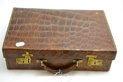 Lot 379 - A crocodile suitcase