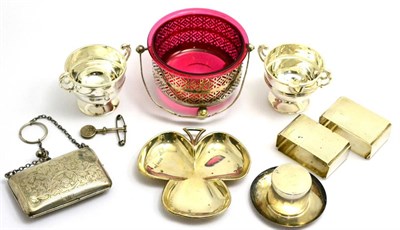 Lot 388 - A silver sugar bowl with cranberry glass liner, a silver purse, two napkin rings, two salts, a...