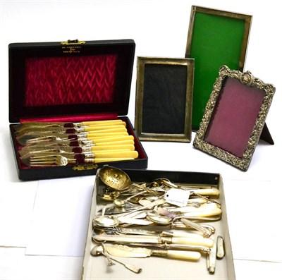 Lot 391 - A collection of silver including three photograph frames, strainer, fruit knives, plated fish...