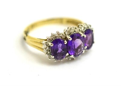 Lot 397 - 9ct gold amethyst and diamond triple cluster ring