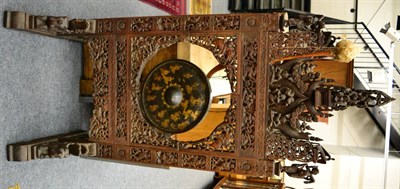 Lot 1084 - A large and impressive Indian ebony dinner gong stand, 19th century, 78.5cm wide x 64cm deep (base)