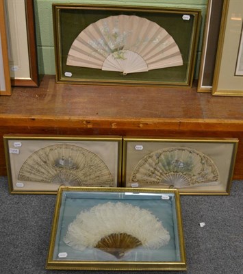 Lot 1208 - Three painted fans in framed and glazed cases and another with cream ostrich feathers (4)