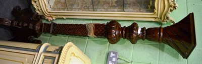 Lot 1227 - A reproduction hardwood torchere carved with fish scales