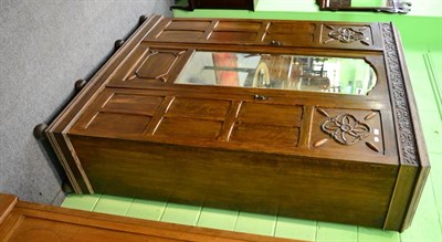 Lot 1231 - A mirrored carved oak wardrobe