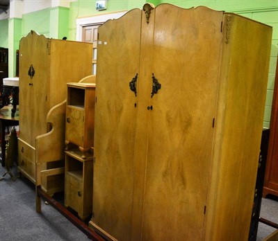 Lot 1241 - A 1950's walnut five piece bedroom suite comprising two wardrobes, pair of bedside tables and a bed