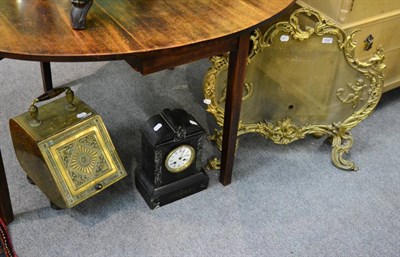 Lot 1242 - A gilt mirror, a brass coal scuttle, a black slate marble mantel clock and a cast brass spark guard