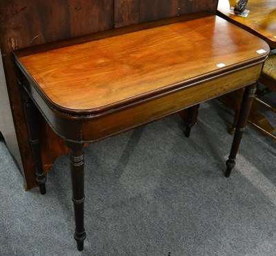 Lot 1261 - A 19th century mahogany fold over tea table