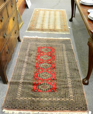 Lot 1272 - A Lahore 'Bukhara' rug, Pakistan, the crimson field with a row of diamond medallions enclosed...