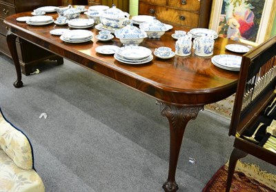 Lot 1273 - A mahogany dining table raised on ball and claw feet