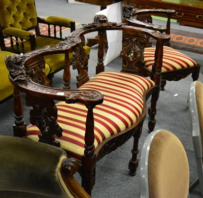 Lot 1280 - A carved period style double horseshoe back sofa together with matching chair