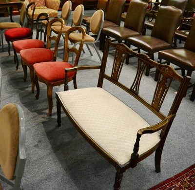 Lot 1293 - Four balloon backed walnut chairs together with an Edwardian inlaid two seater hall chair